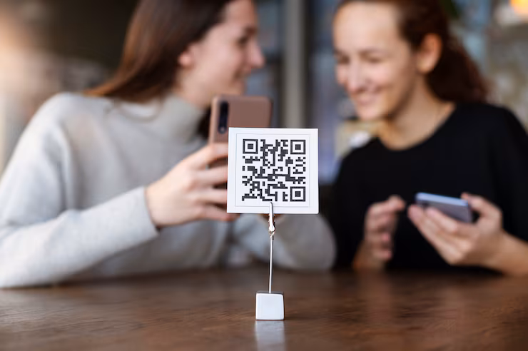 Young woman accessing event information and resources through QR code scanning system