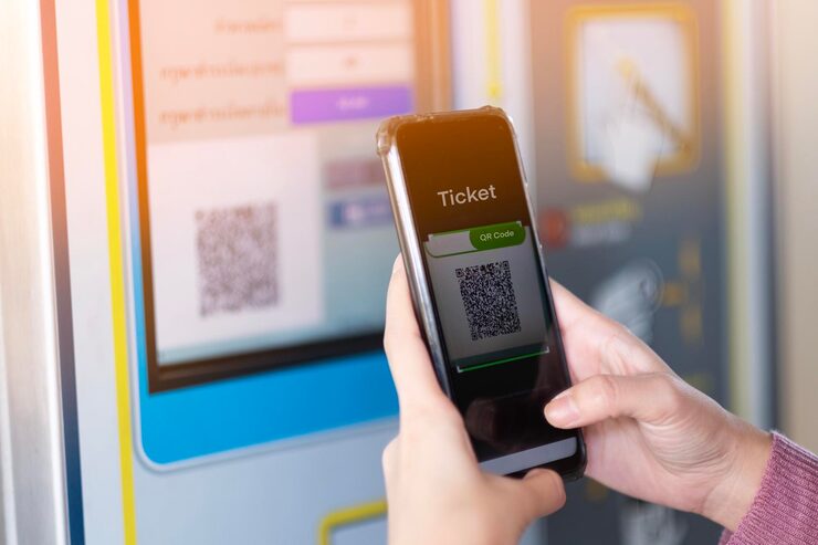 Close-up of hand scanning QR code on mobile device for event ticket verification and digital check-in system