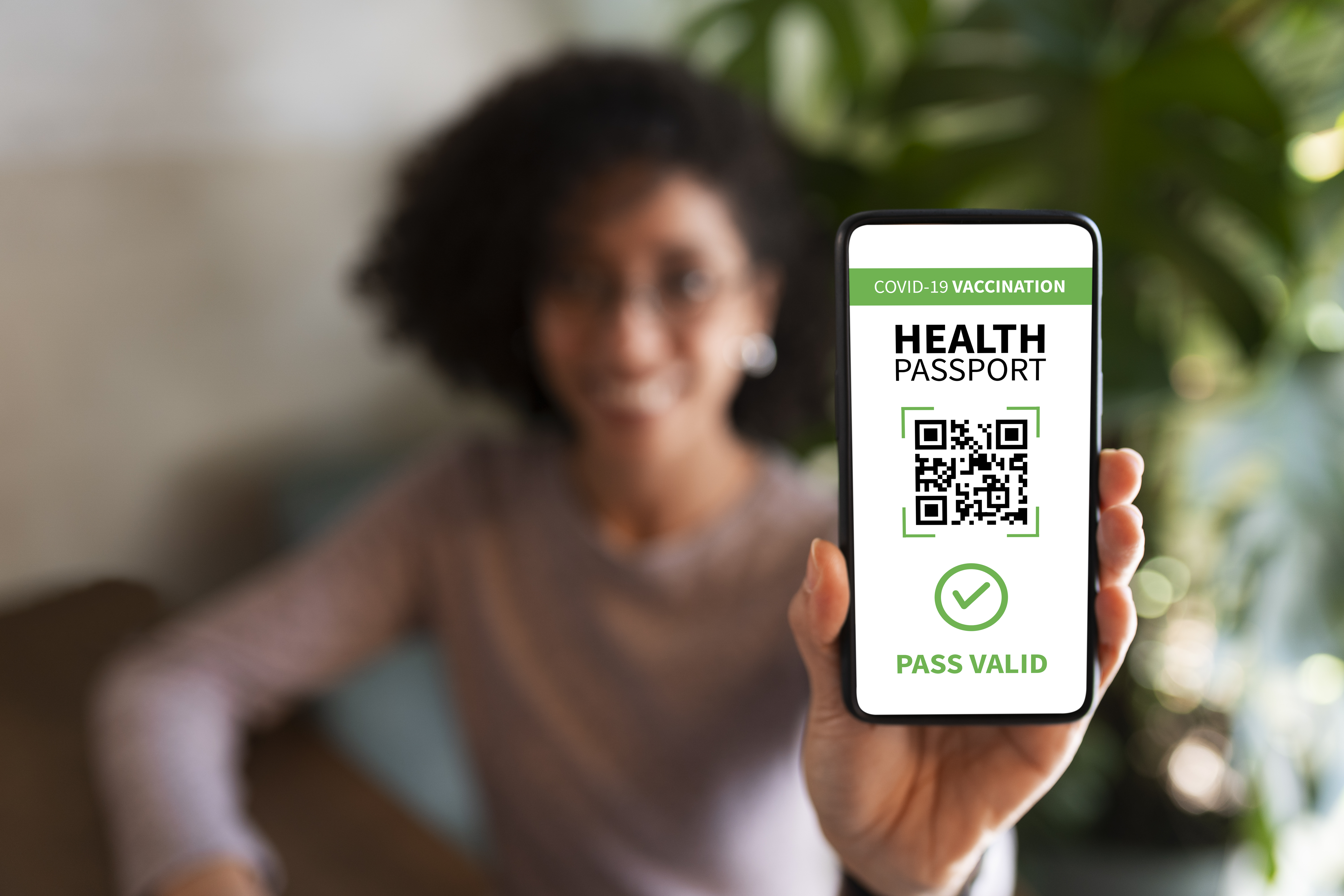 Woman using health tracking technology with QR code for wellness monitoring and fitness progress evaluation