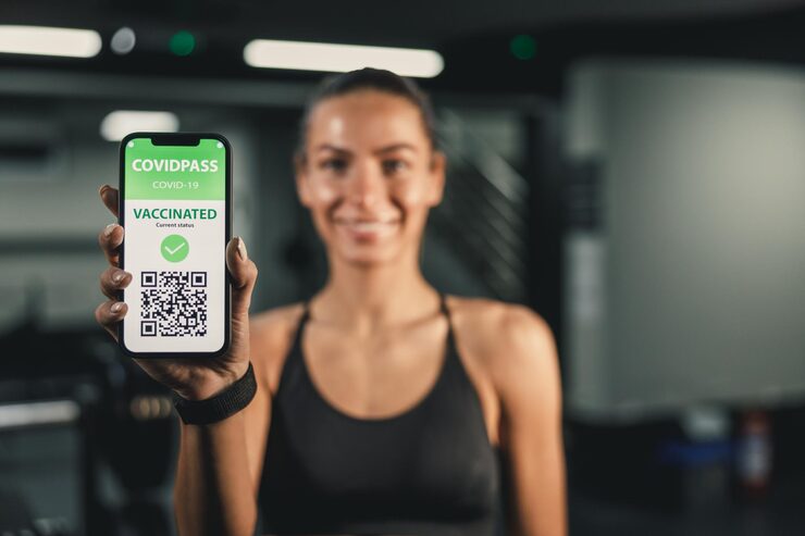 Muscular athlete demonstrating strength training with QR code access to safe resistance exercise programs