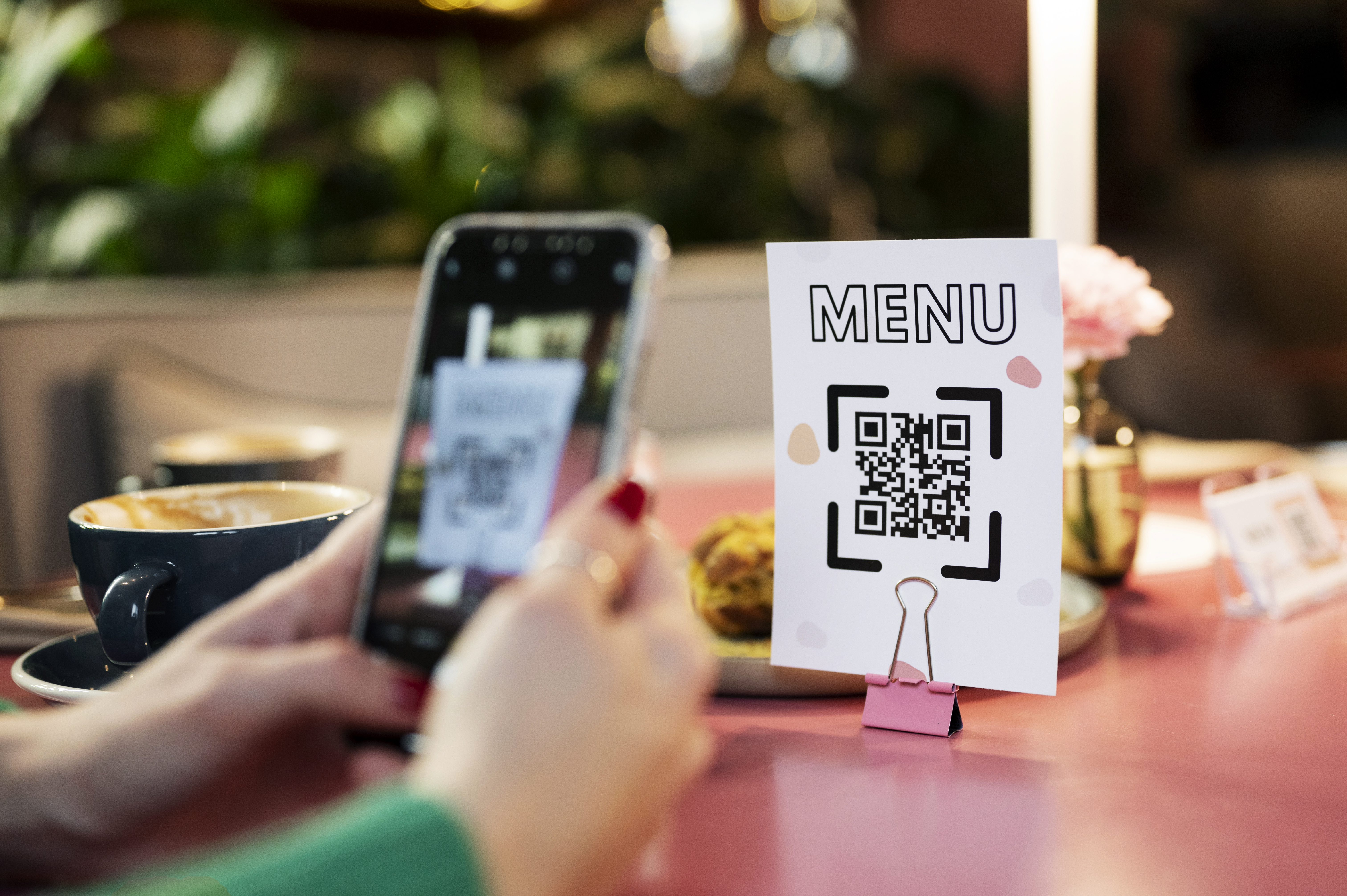 Restaurant customer scanning QR code menu sign for contactless dining and digital ordering