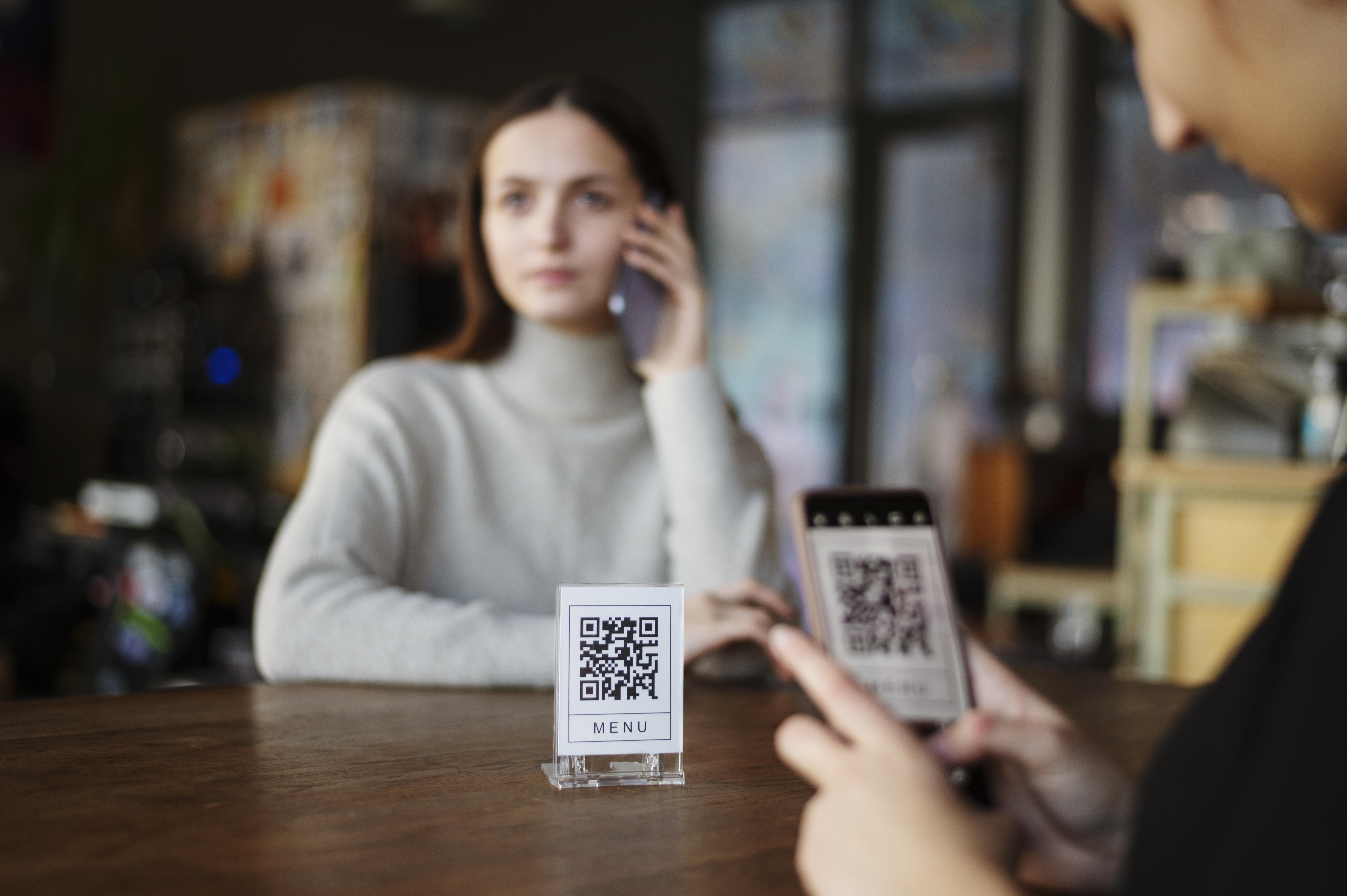 Person scanning QR code for workplace visitor registration and professional contact management system
